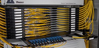 Close up of fiber optic distribution frame cassettes with fiber optic cables and connectors