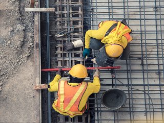 Construction men grounding within the floor outdoor 