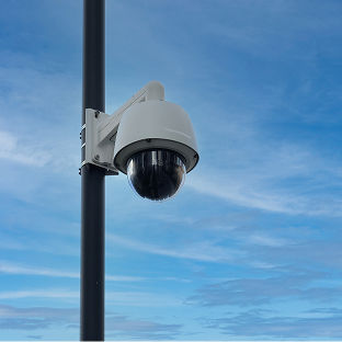 A security camera mounted on an parking lot light pole