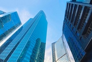 Looking up at a variety of skyscrapers in different sizes
