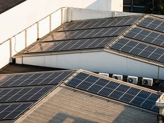Factory with solar panels and heat pumps on roof