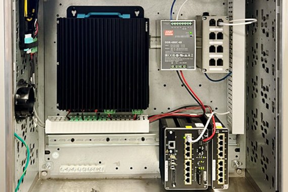 Figure 2: TrueEdge Wall Mount Cabinet populated with an FMPS Reciever, DIN Mount Patch Panel, and copper and fiber cabling that makes up part of the installation