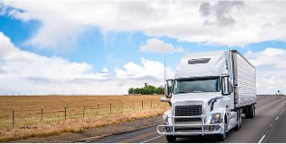 Semi-truck driving through rural area