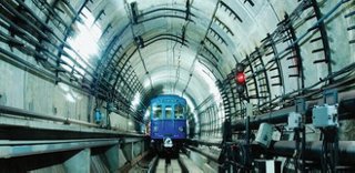 Cable cleats inside a railroad tunnel with a train