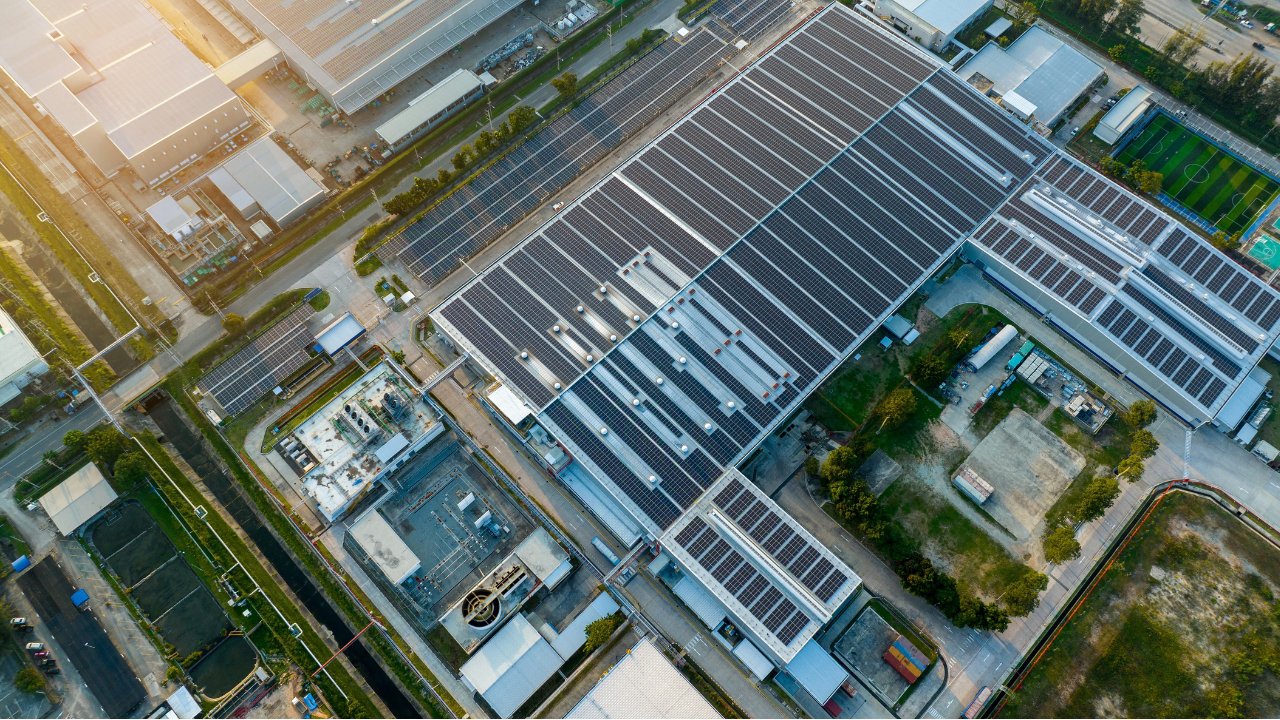 Top view Solar Panels on Warehouse Factory. Solar photo voltaic panels system power or Solar Cell on industrial building roof for producing green ecological electricity. Production of renewable energy