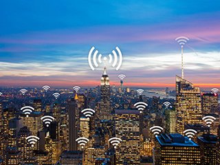 A cityscape of highrise office buildings with wi-fi icon