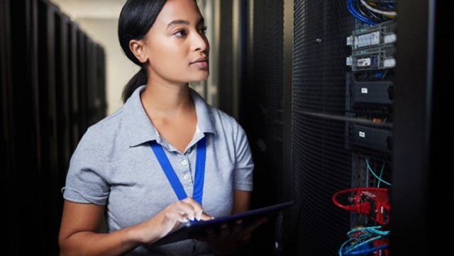 Data Center manager checks on the equipment inside a cabinet