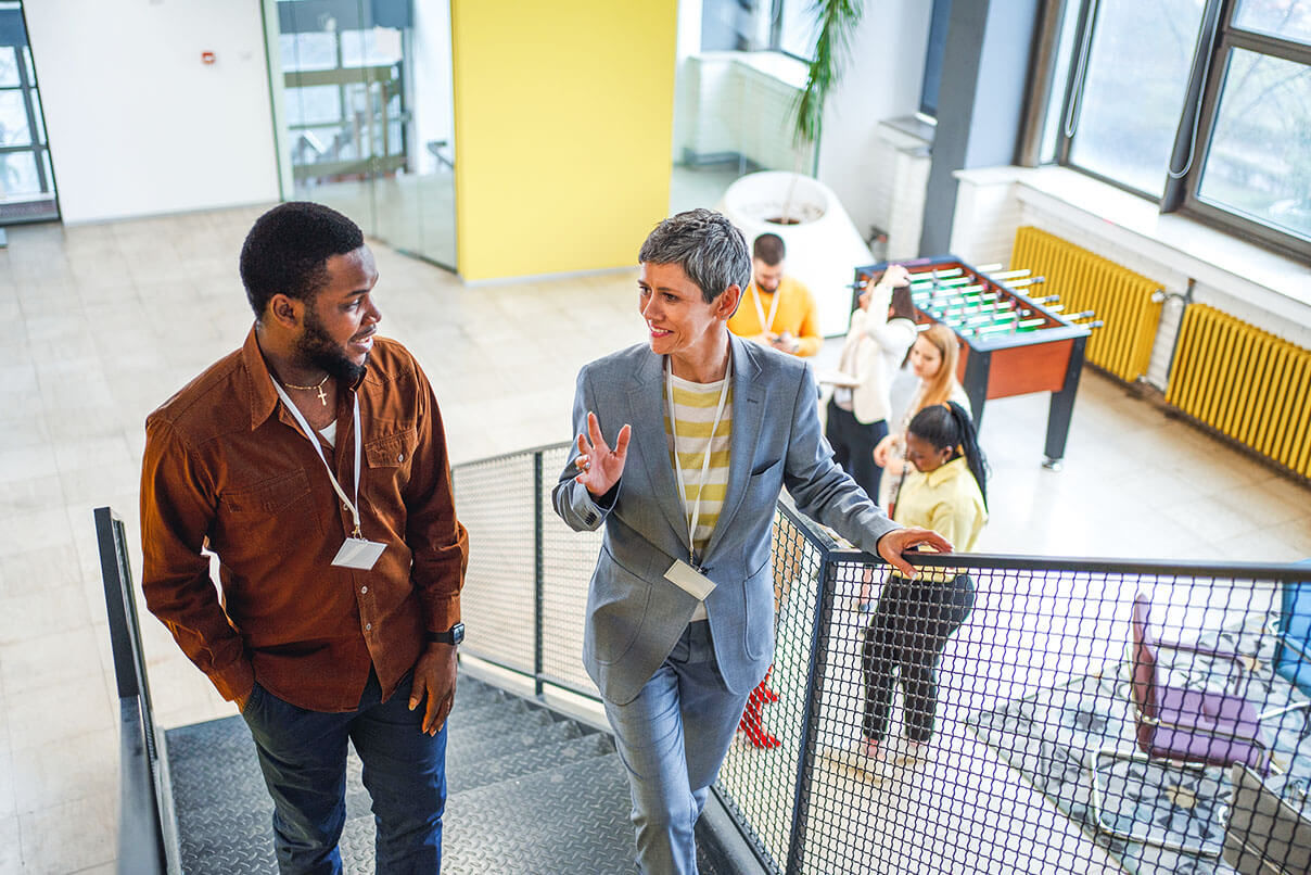 Two people at the workplace having a conversation.