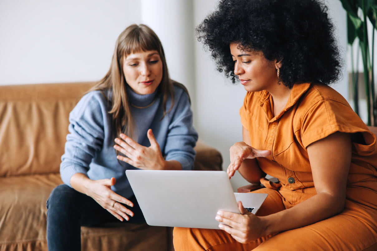 HR leader and recruiter reviewing candidates on a laptop.