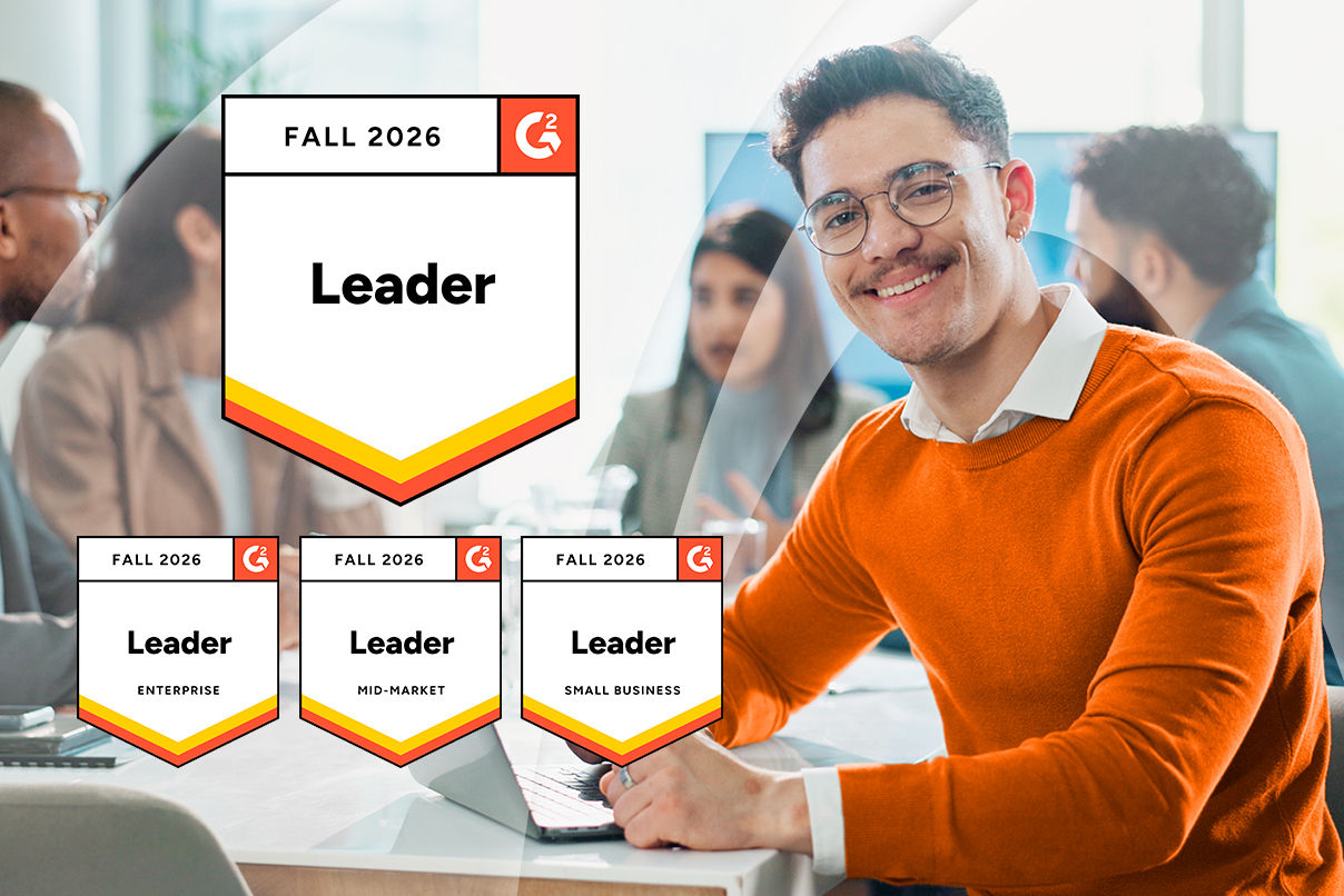 Office scene featuring a person seated beside a laptop, with G2 Fall 2026 award badges highlighting Leader recognition across Enterprise, Mid-Market, and Small Business categories.