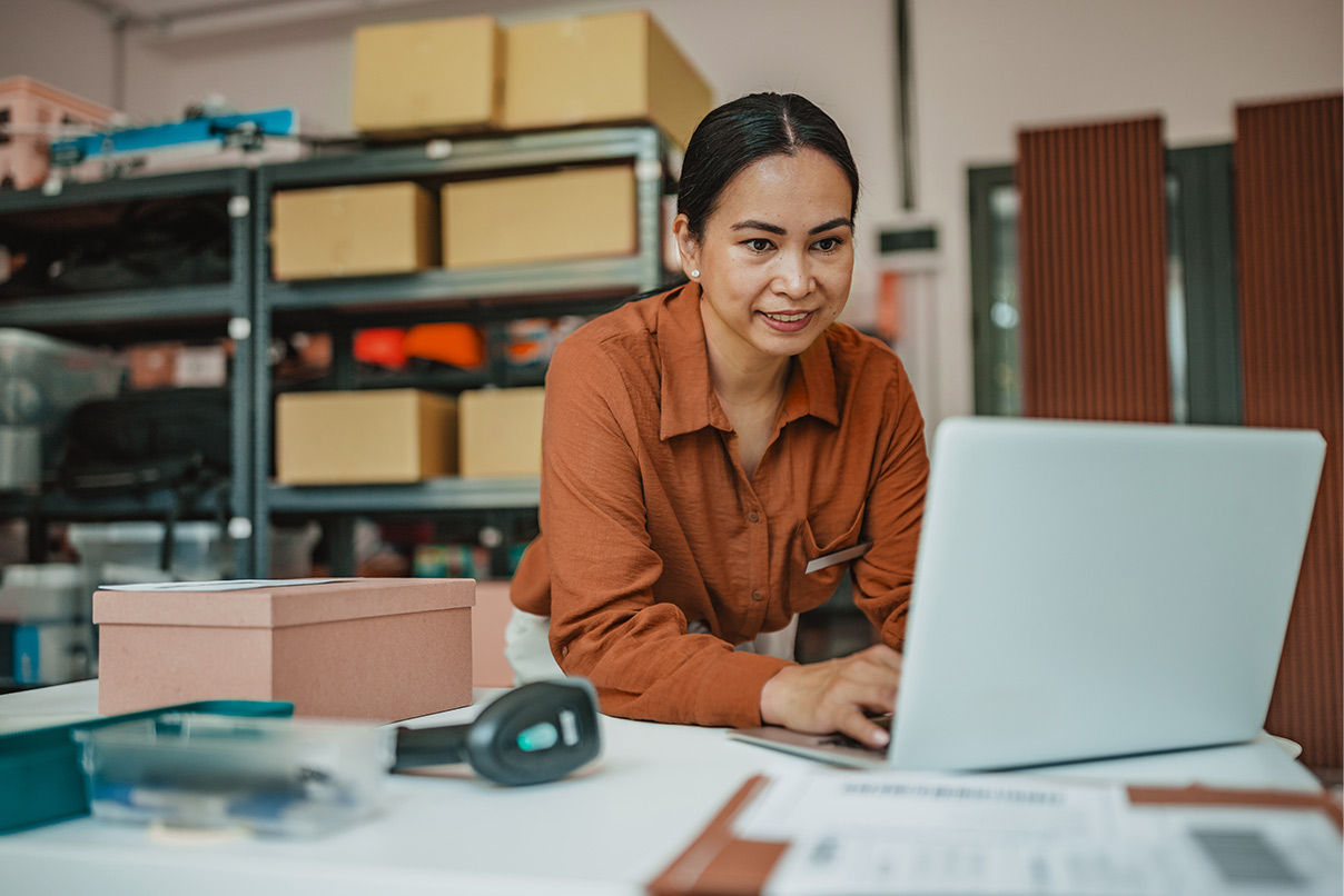 Woman on laptop in mail room