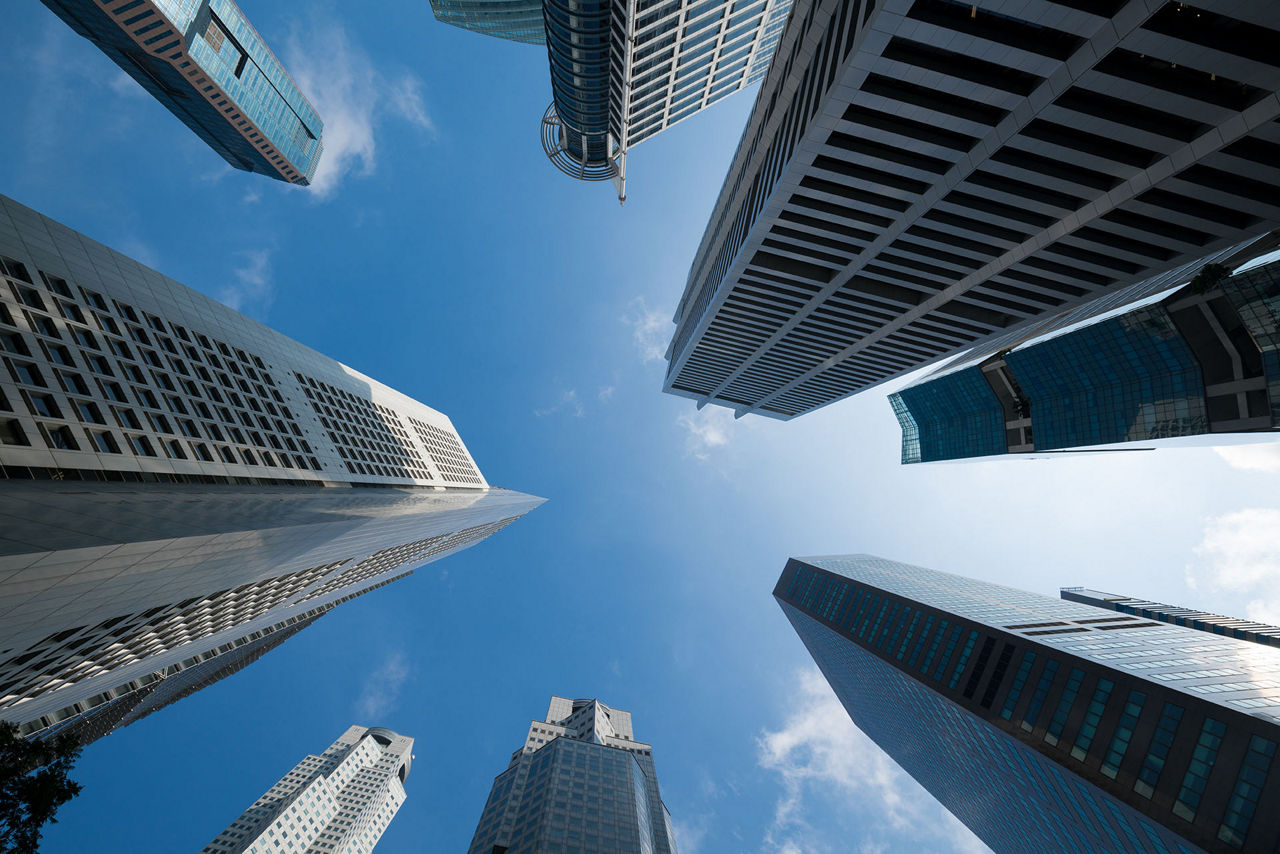 Looking up at business buildings in downtown, Skyscrapers in Commercial Area, blue sky background