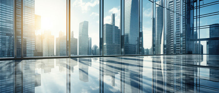 Modern city skyline reflected through glass office windows and a polished floor