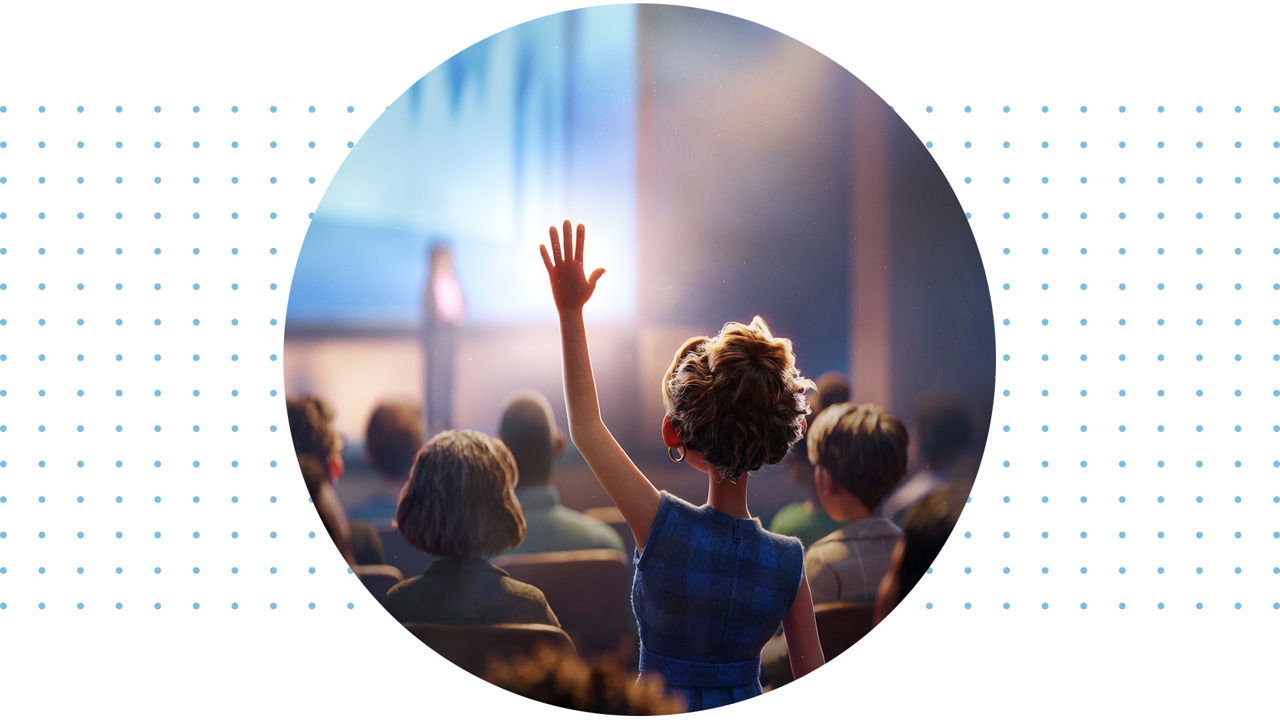 Woman raising hand at a conference.