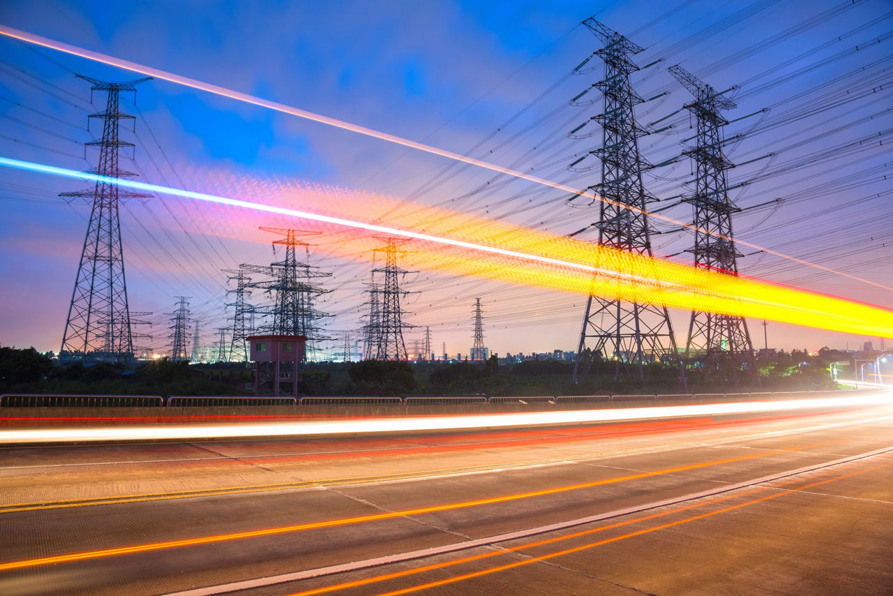 High voltage, high speed road car track in the background of high voltage towers