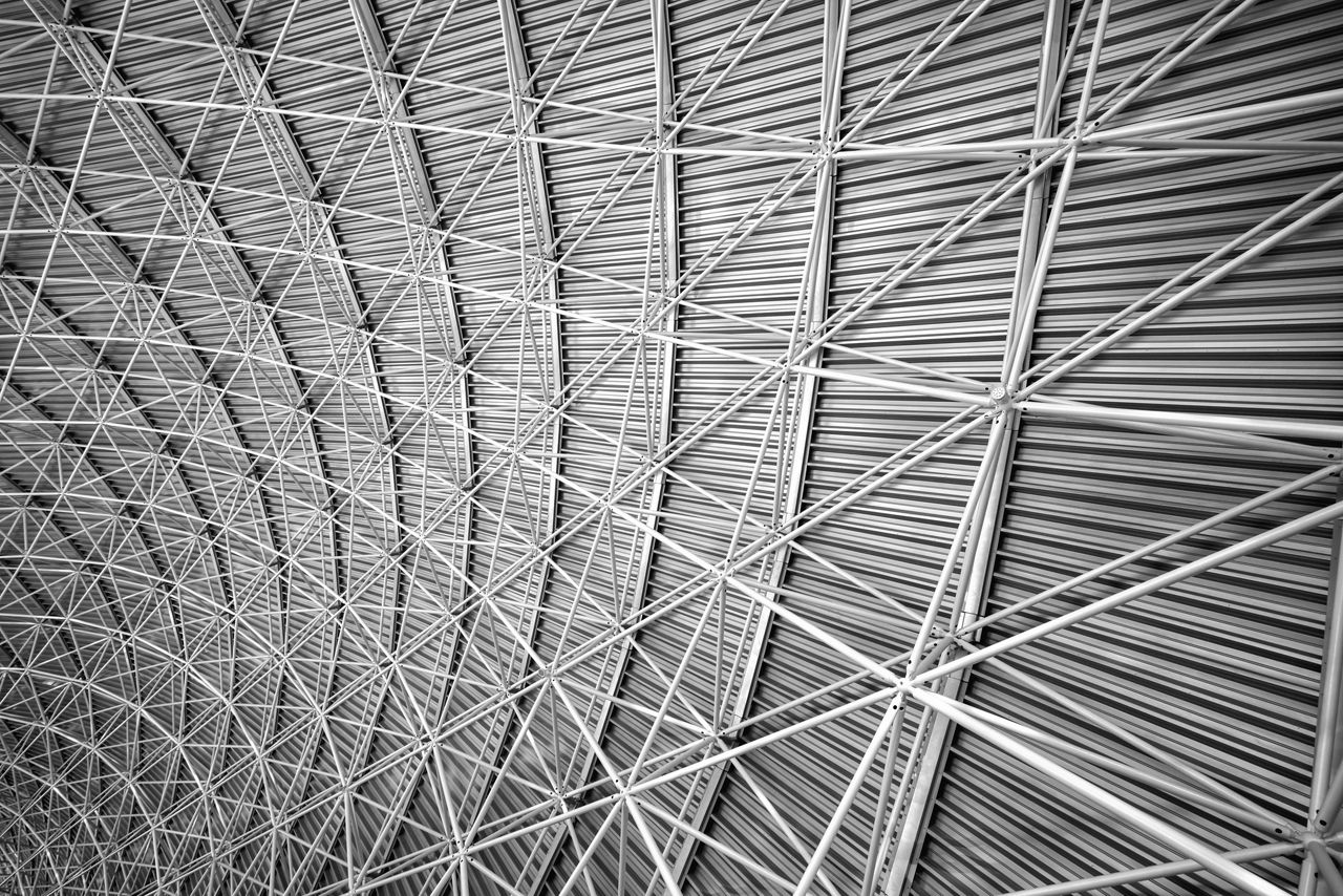 Modern interior architecture of metal steel roof structure of airport or industrial factory.