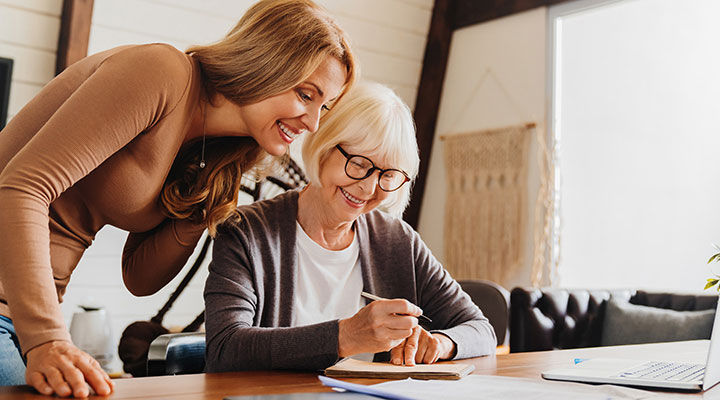 Investment advisor consulting with retired woman at home.