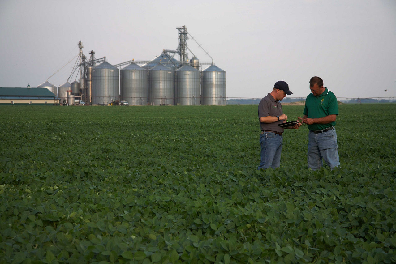 Sales rep and customer in field.