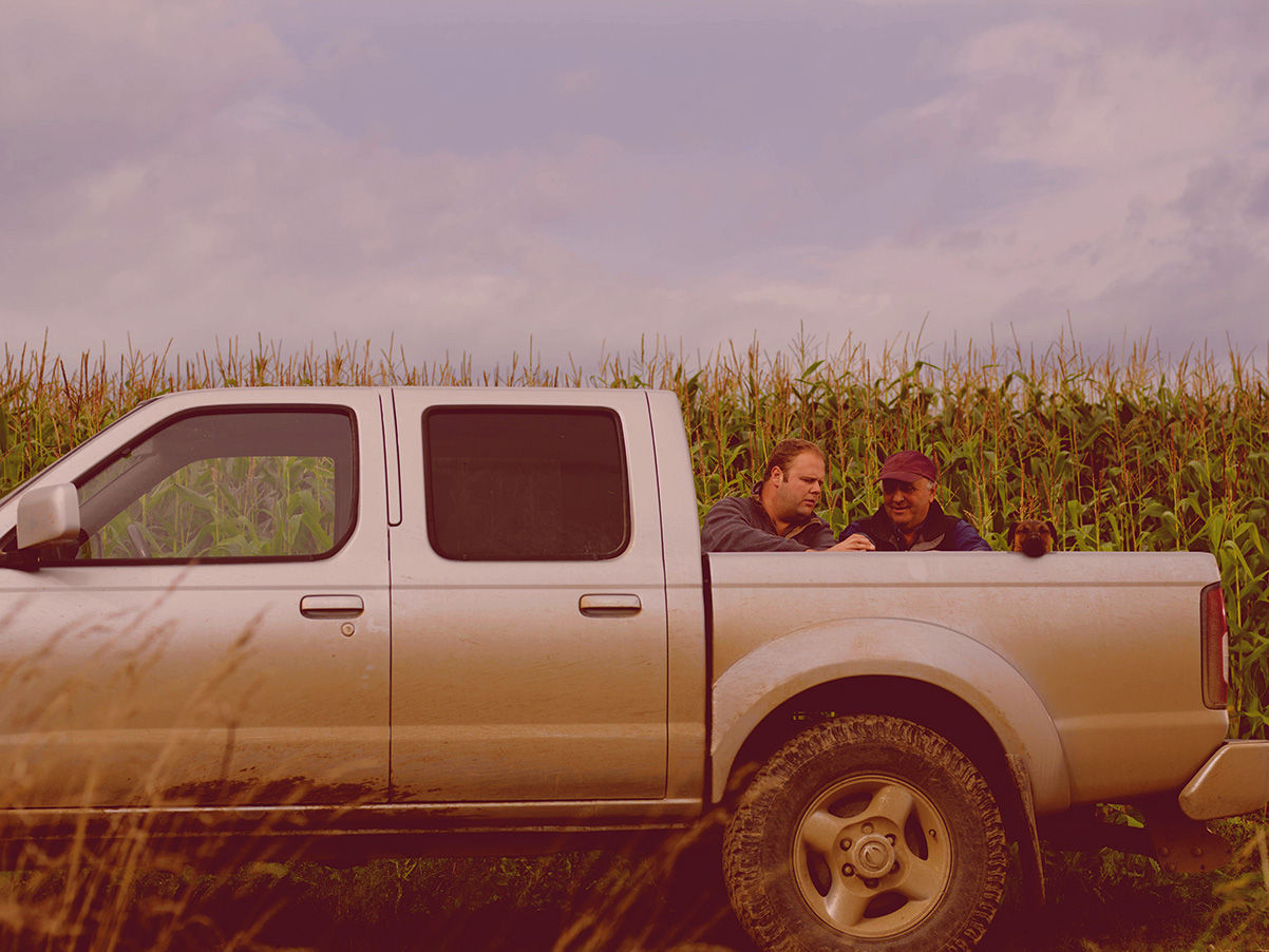 Two men talking at a truck bed
