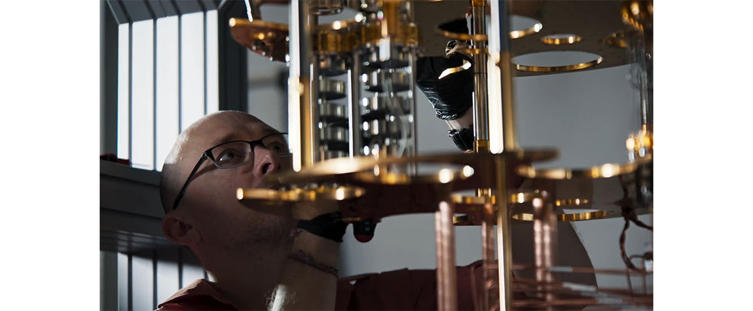 image of a scientist looking at the inside of a quantum computer
