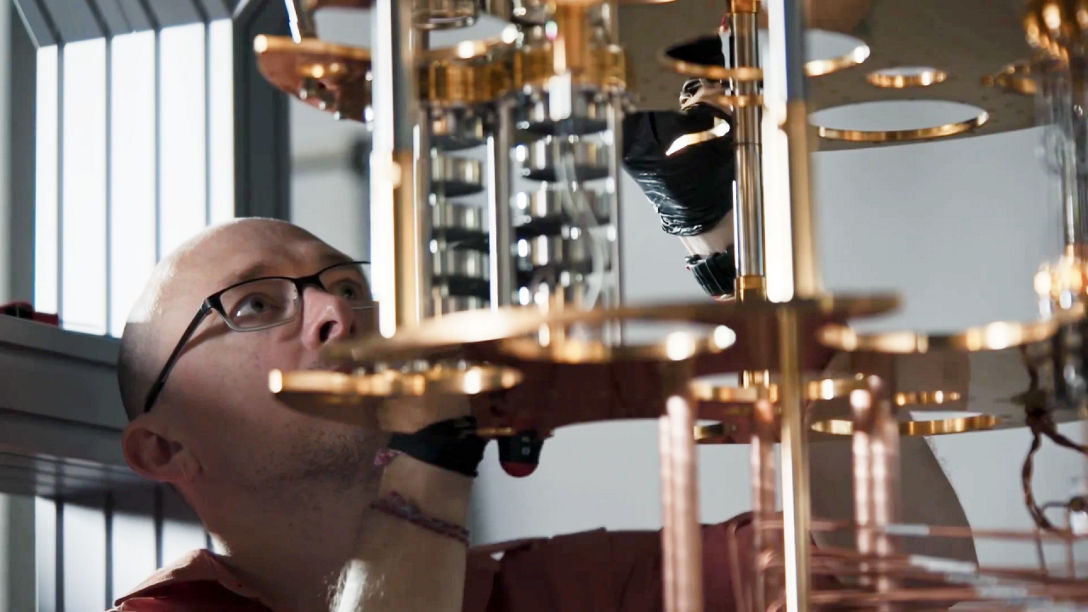 image of a scientist looking at the inside of a quantum computer