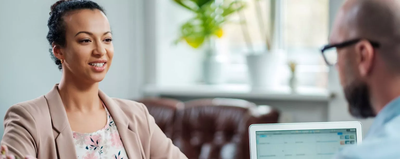 A confident job candidate is well-prepared for her second interview as she answers questions and engages in discussion with the hiring manager.