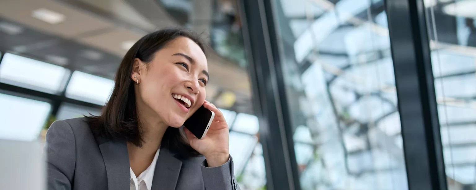 A lady talking on the phone in the office