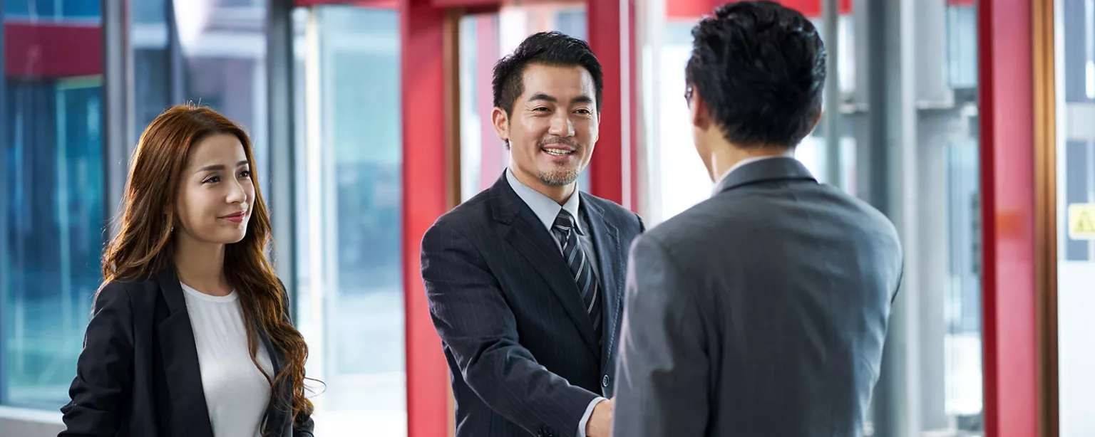 Two businessmen meet and shake hands 