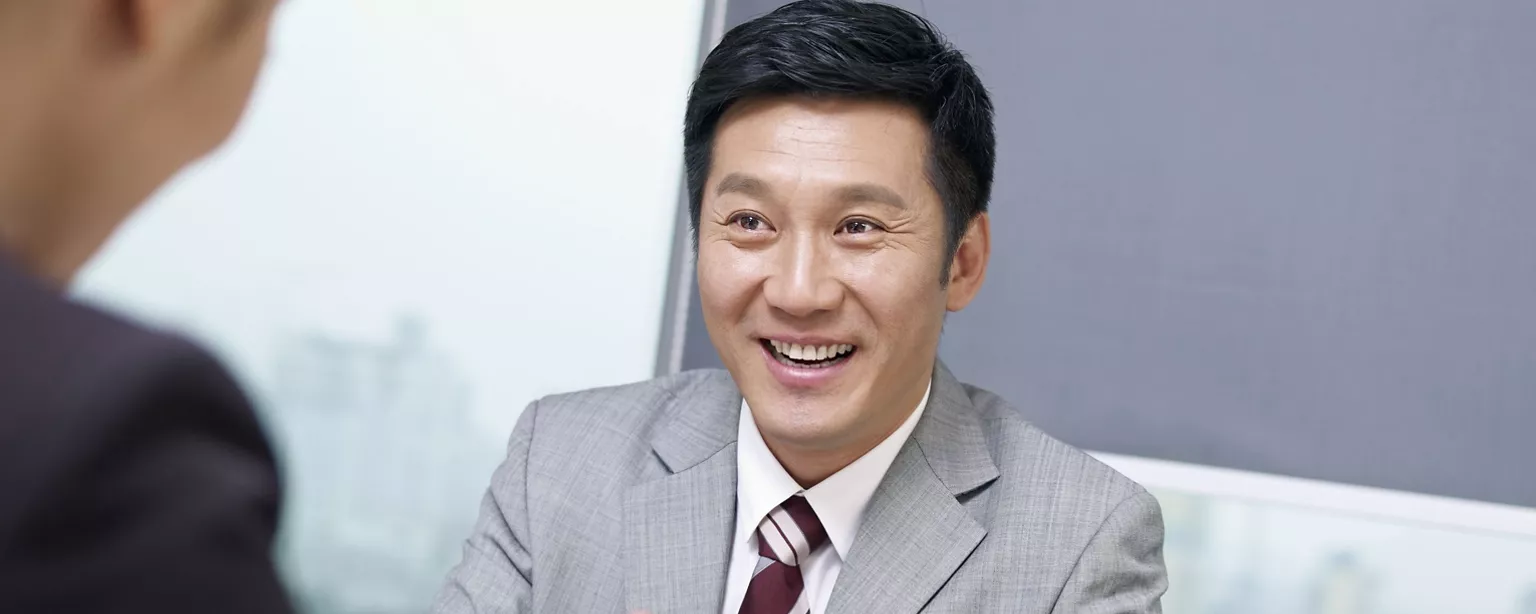 A businessman talking with one candidate with smile