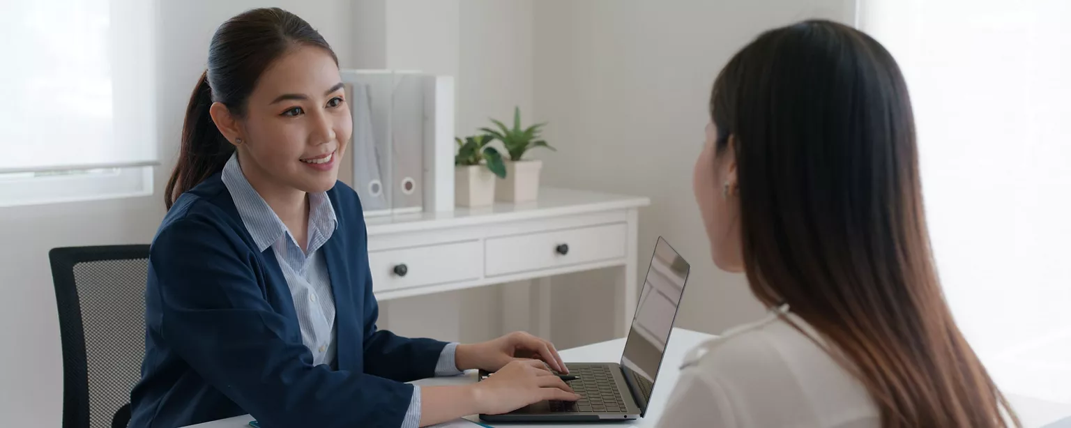 two businesswomen communicate in the office sitting