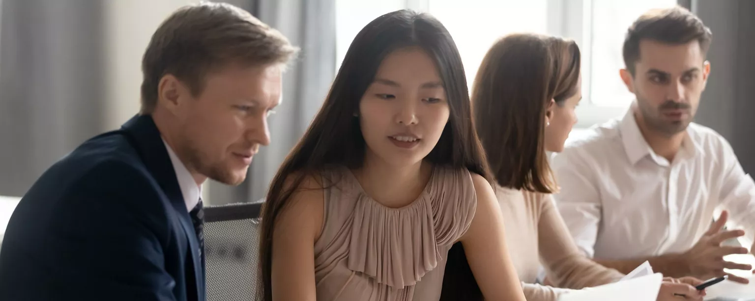 Two businessman separately discussing with a female team member