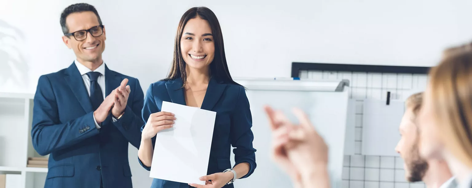 A lady giving a presentation in the front of the office