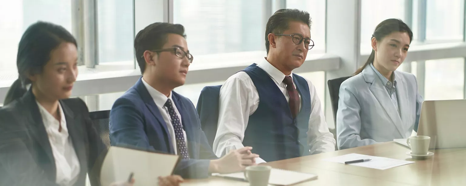 Four interviewers interviewing candidates in the conference room