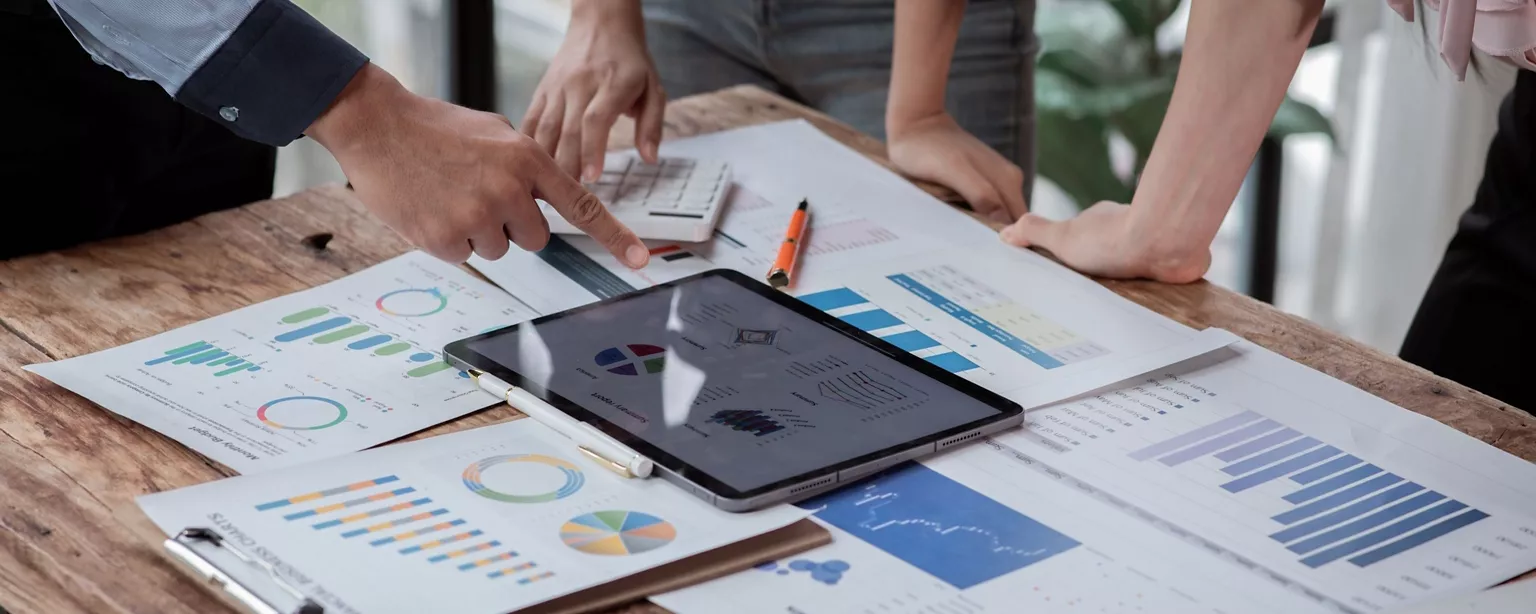 The profit analysis team discussing around the table in the office