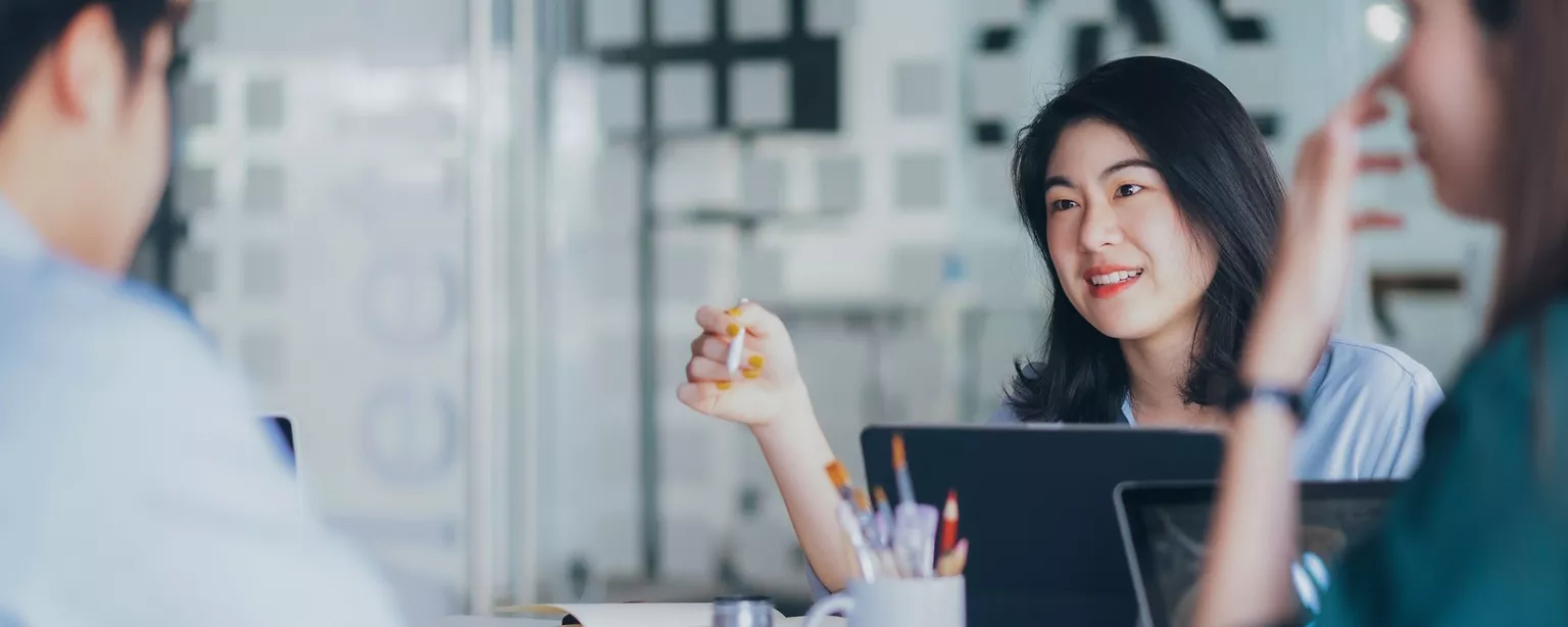 Two office ladies and one business men discussing accounting issues