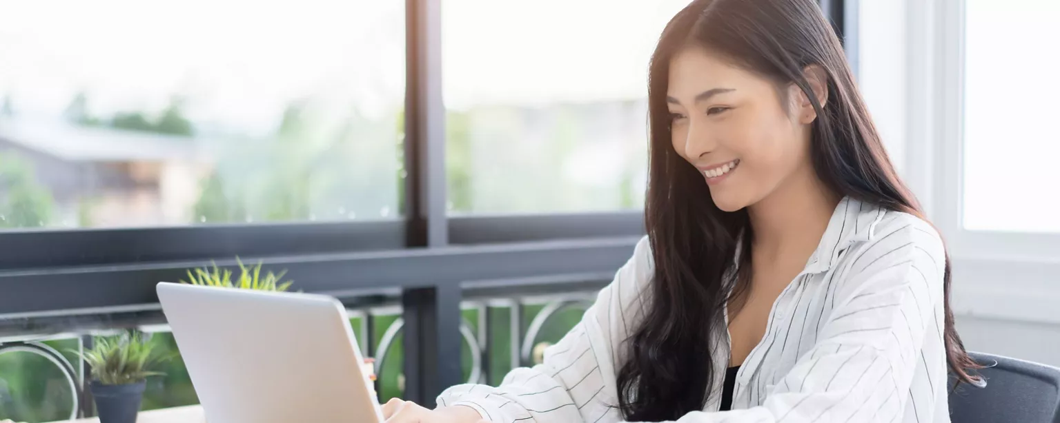 A lady working with laptop in the office