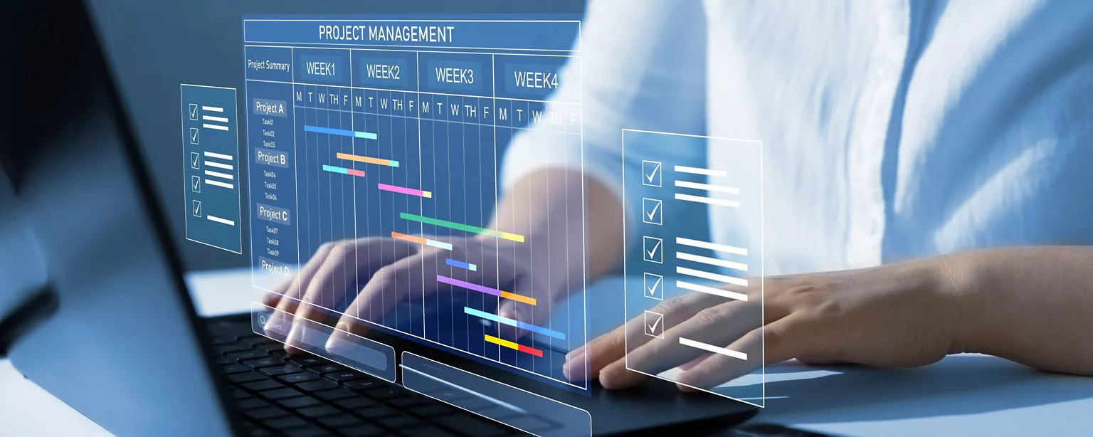 A business lady typing at the computers showing Ganta chart