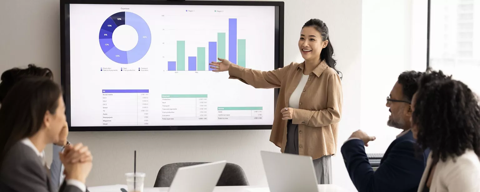 A businesswoman doing presentation at the front of the meeting room