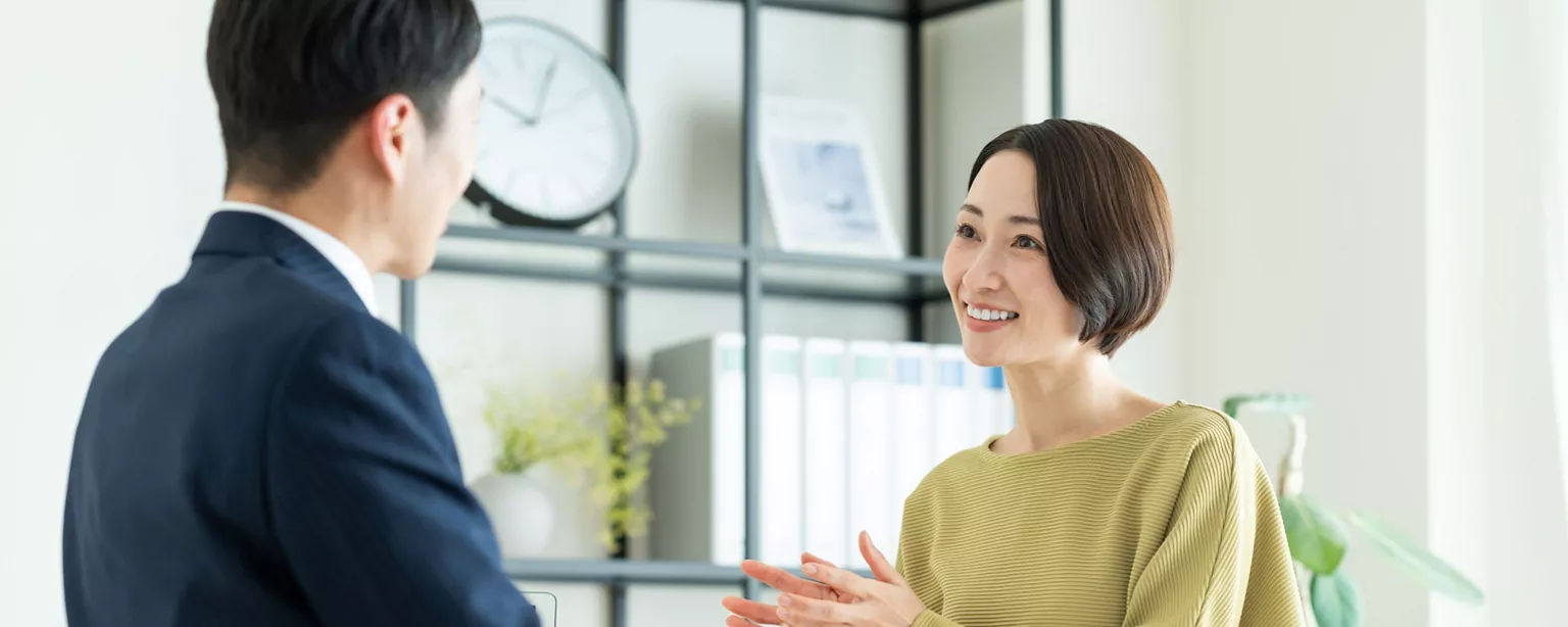 An asian businesswoman interviewing a male candidate