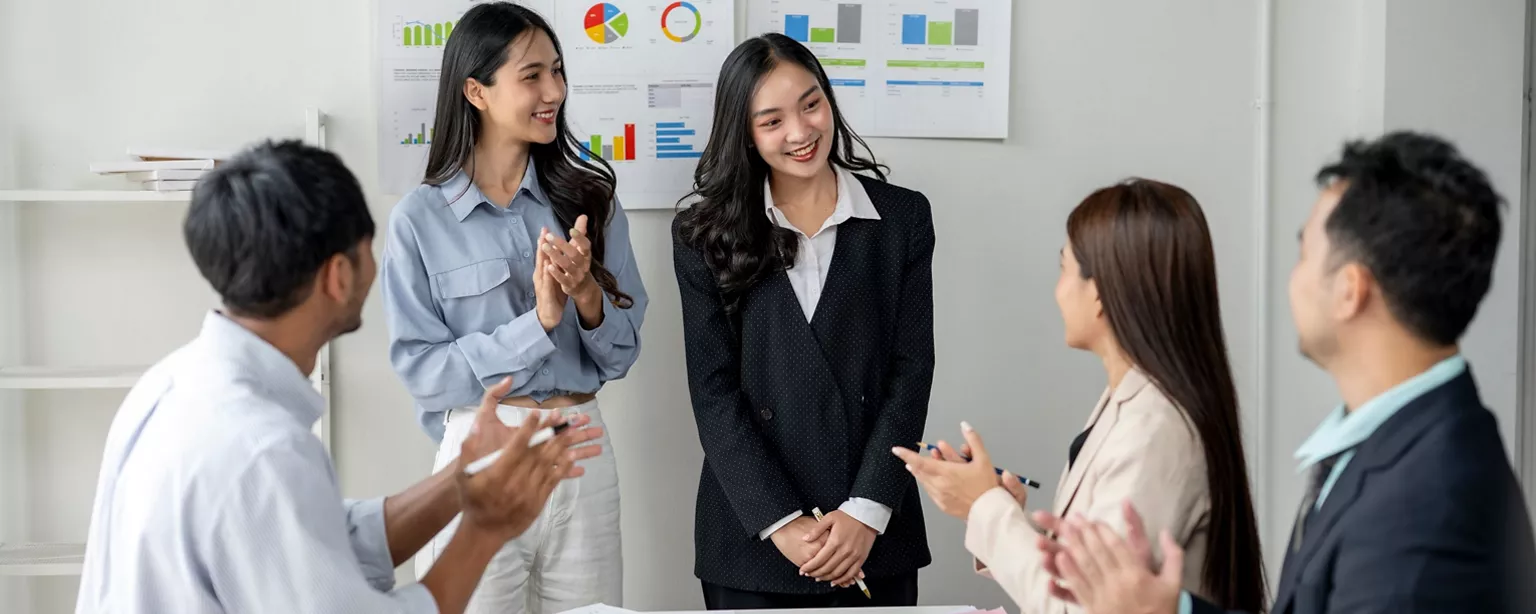 asian team members celebrating