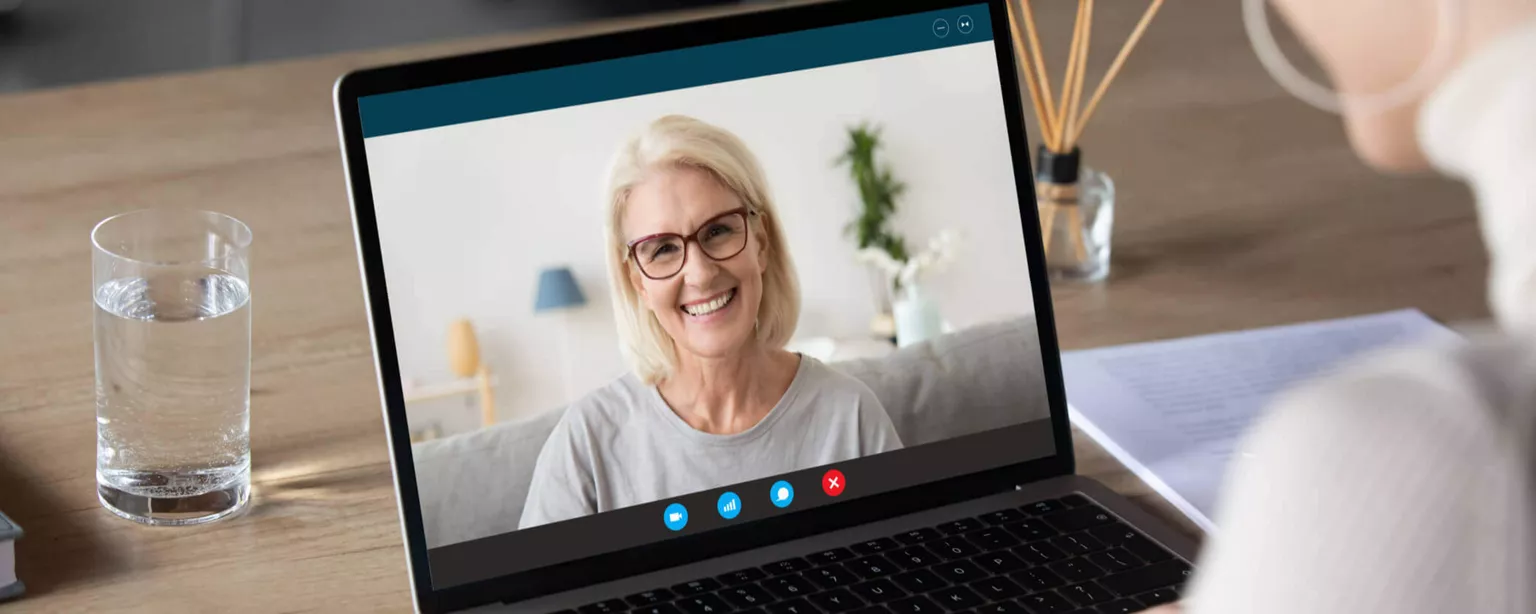 A mentor talking with her mentee during a video call.