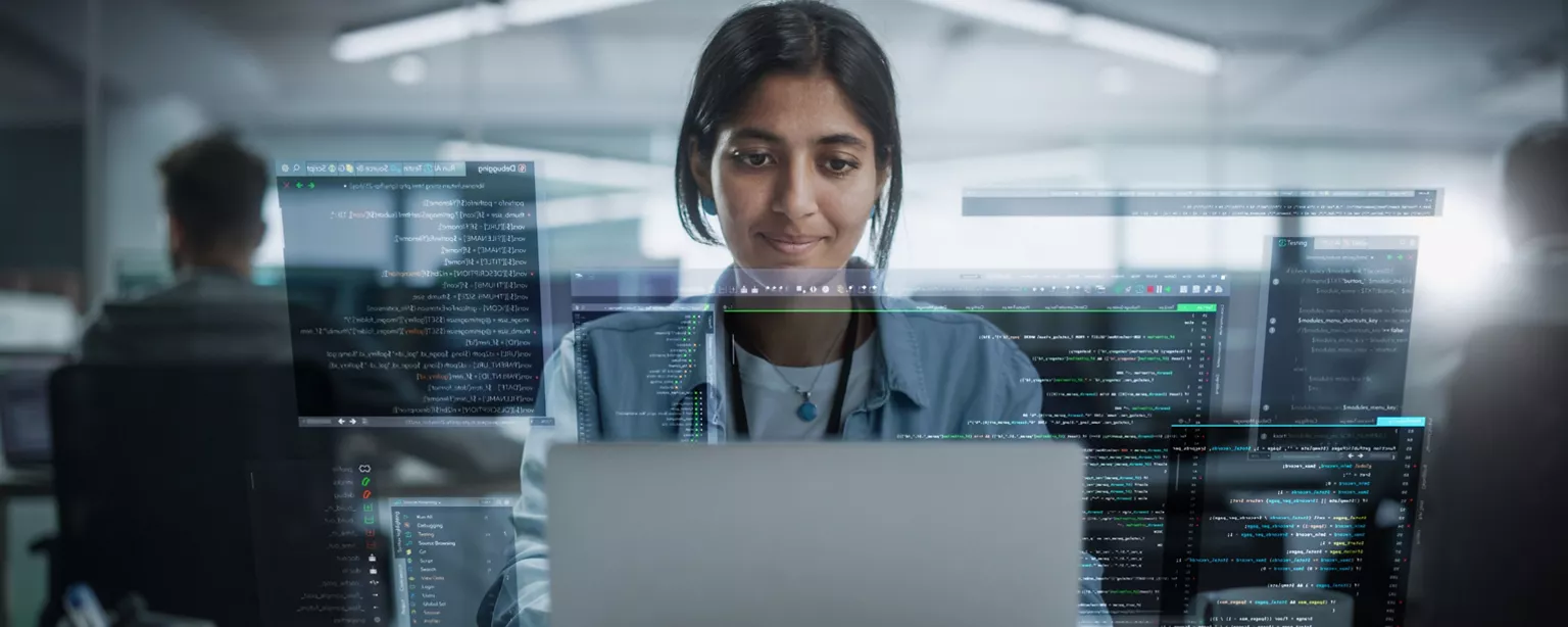 A developer works at her desk using object-oriented programming.