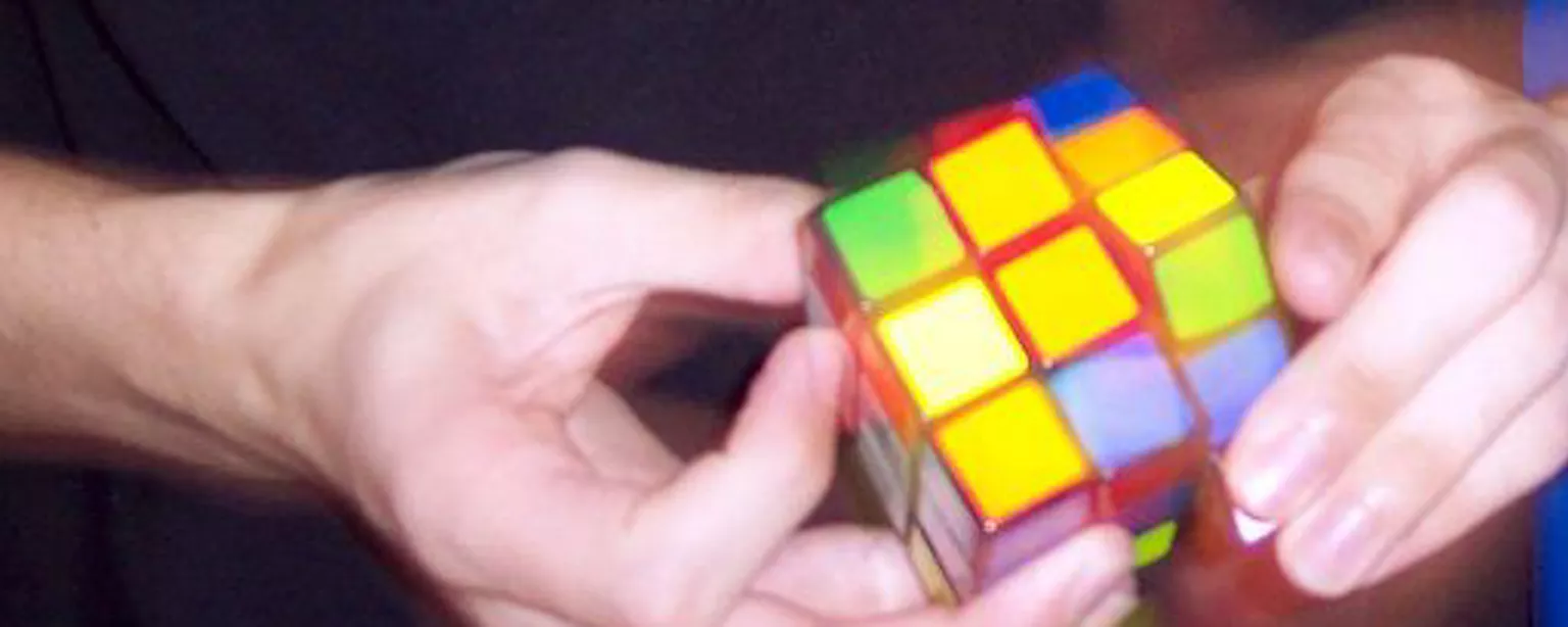 Hands with Rubik's Cube showing job satisfaction