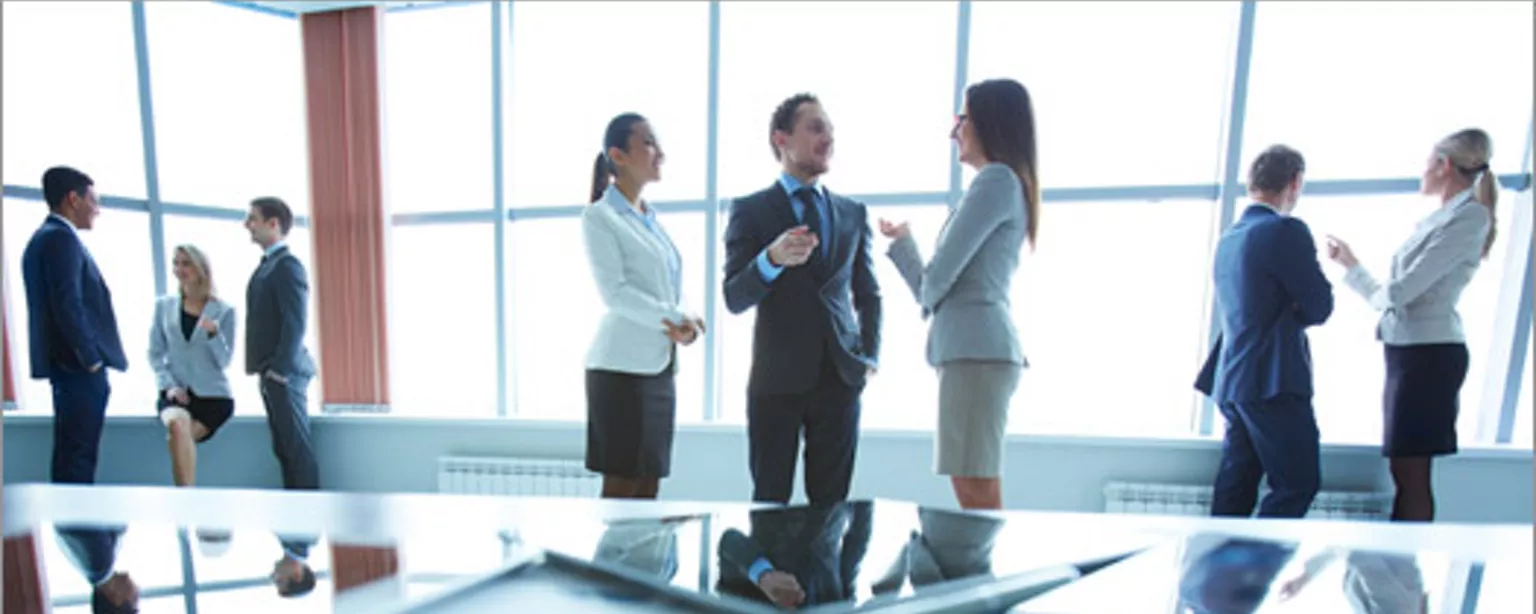 People talking in small groups you might find at finance conferences