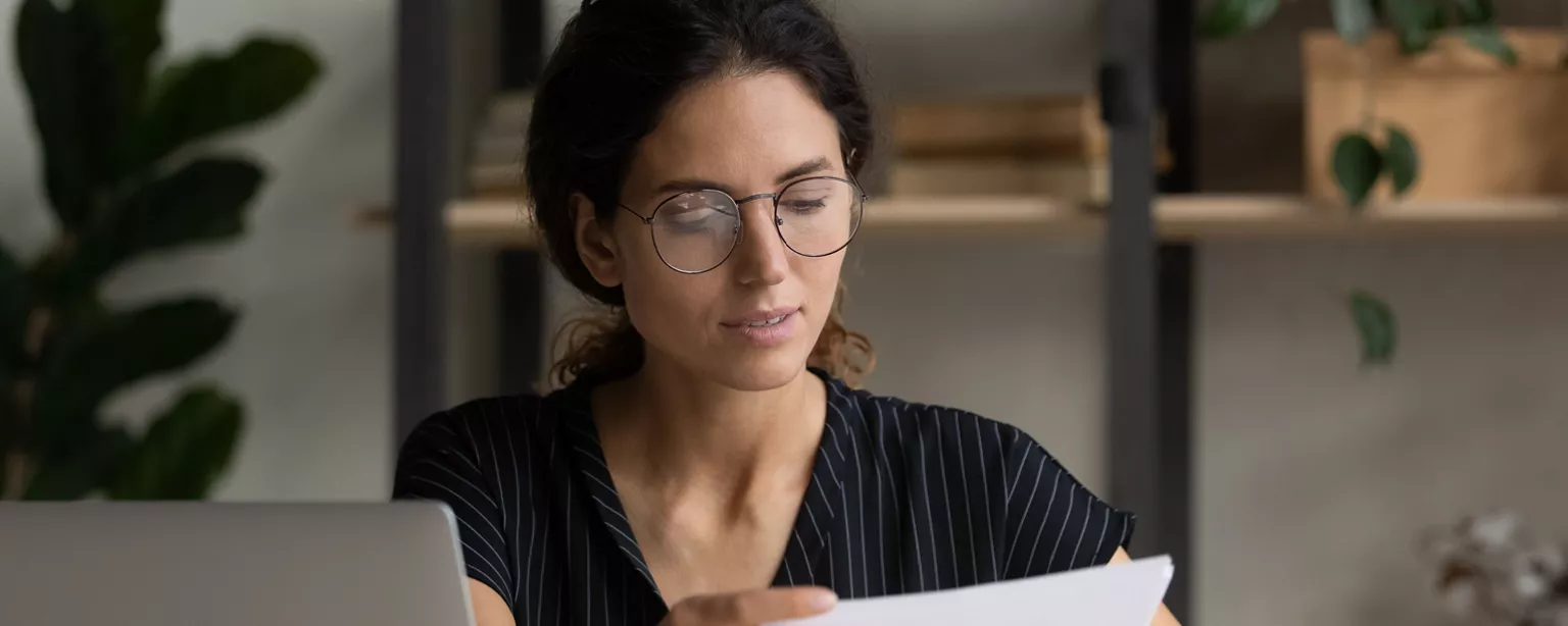 A woman concentrates as she prepares her legal resume. 