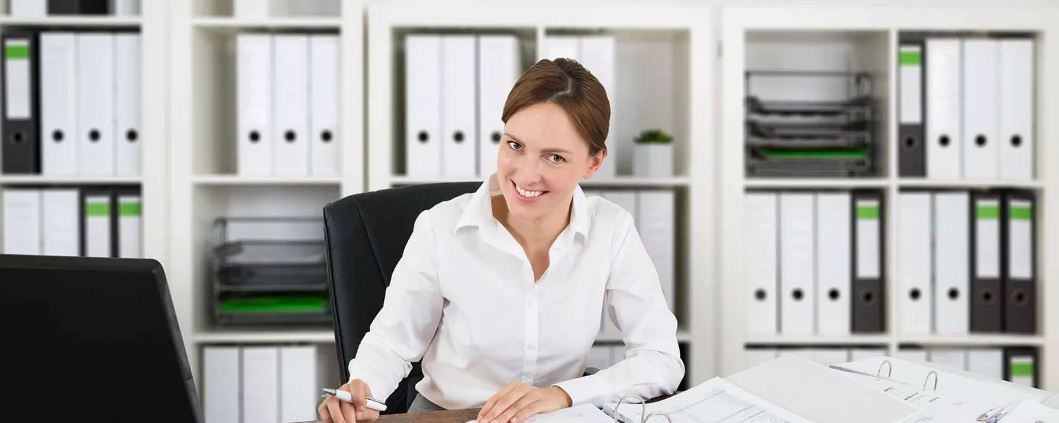 Woman working at desk where she knows how to answer: is accounting a good career choice