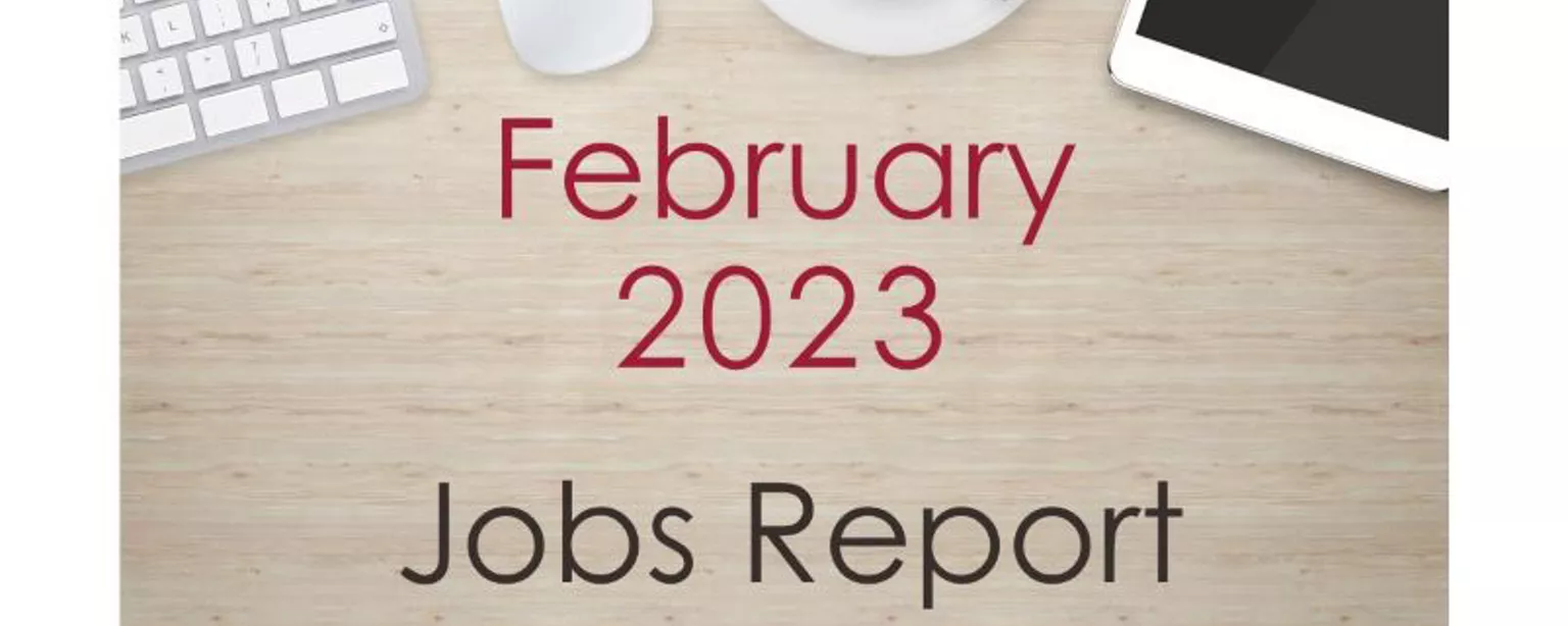 Desktop with keyboard, tablet and coffee cup, with text that reads: February 2023 Jobs Report.