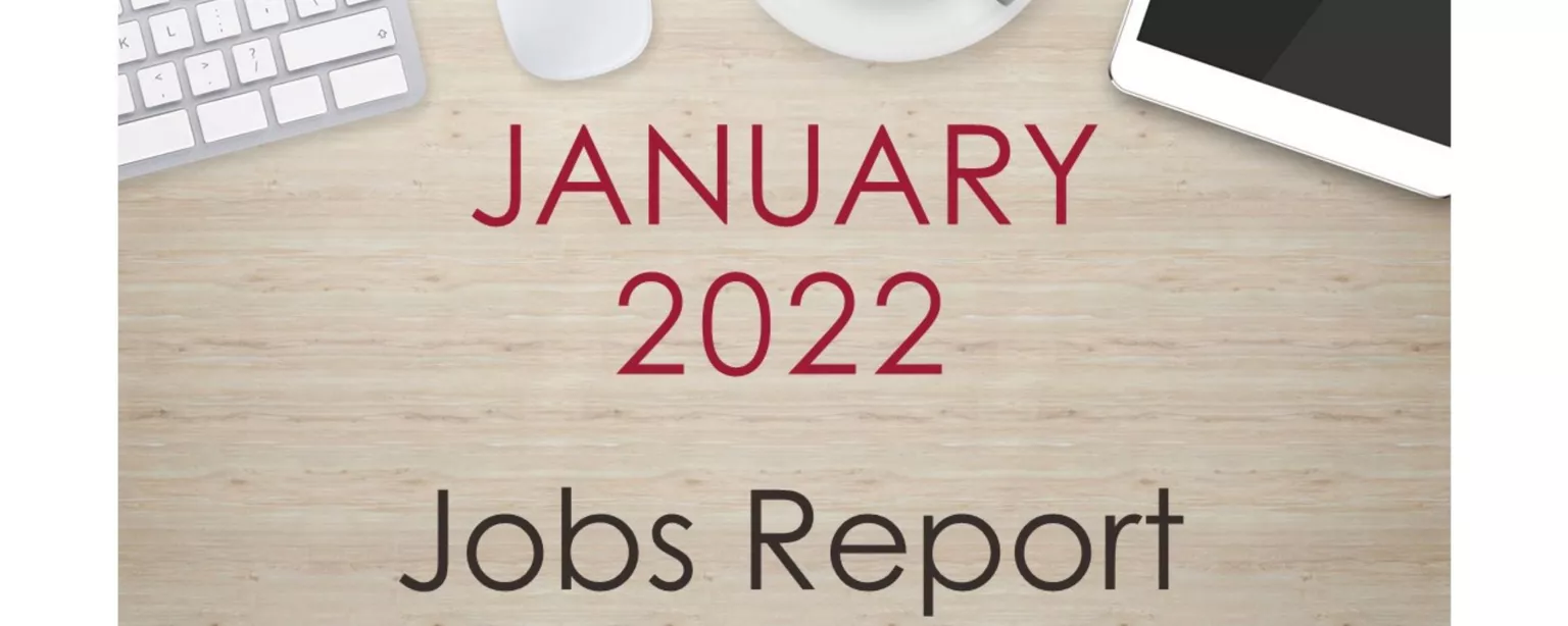 Desktop with keyboard, tablet and coffee cup, with text that reads: January 2022 Jobs Report