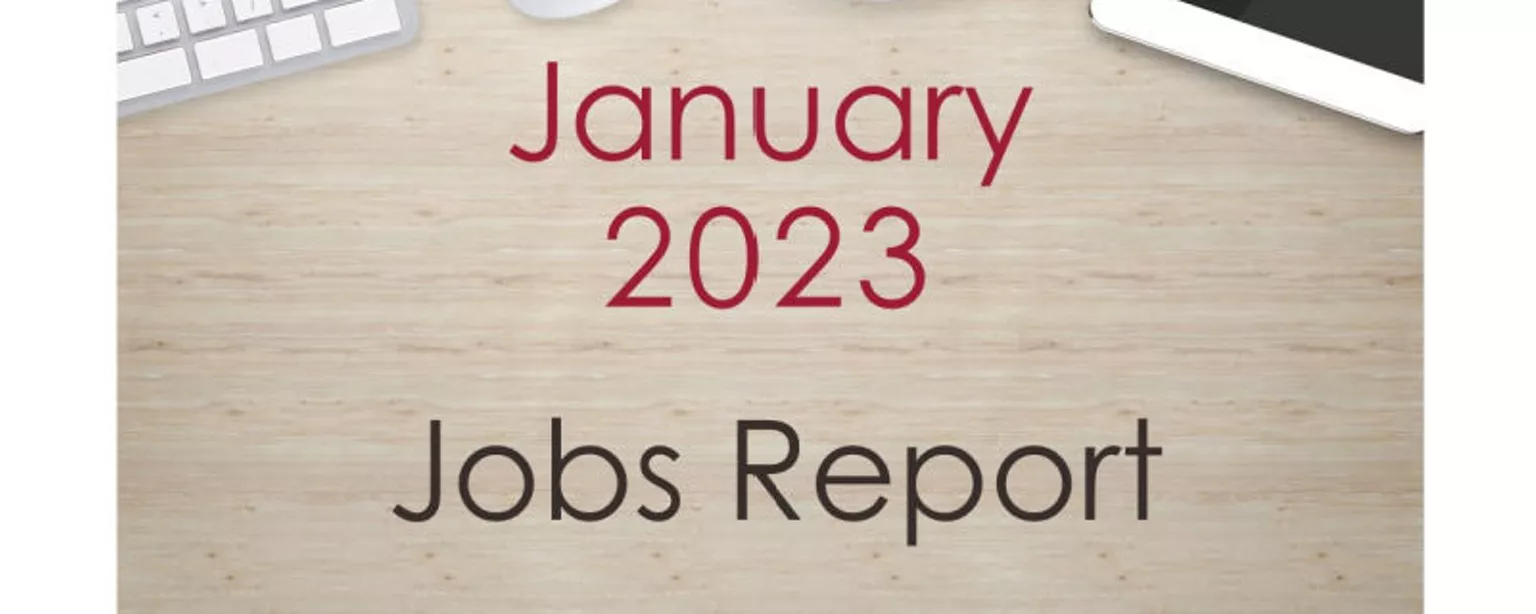 Desktop with keyboard, tablet and coffee cup, with text that reads: January 2023 Jobs Report.