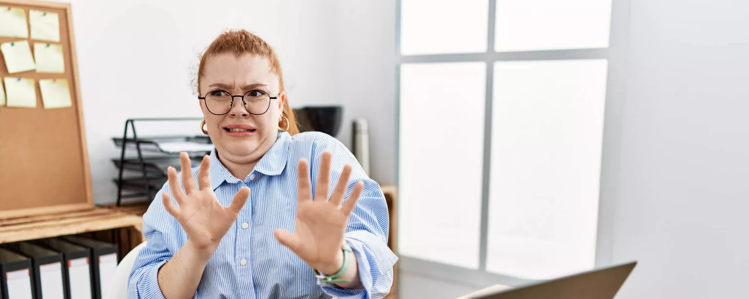 Resumania®: 5 Bad Resume Examples to Watch For — woman holds hands up in disgust in office setting